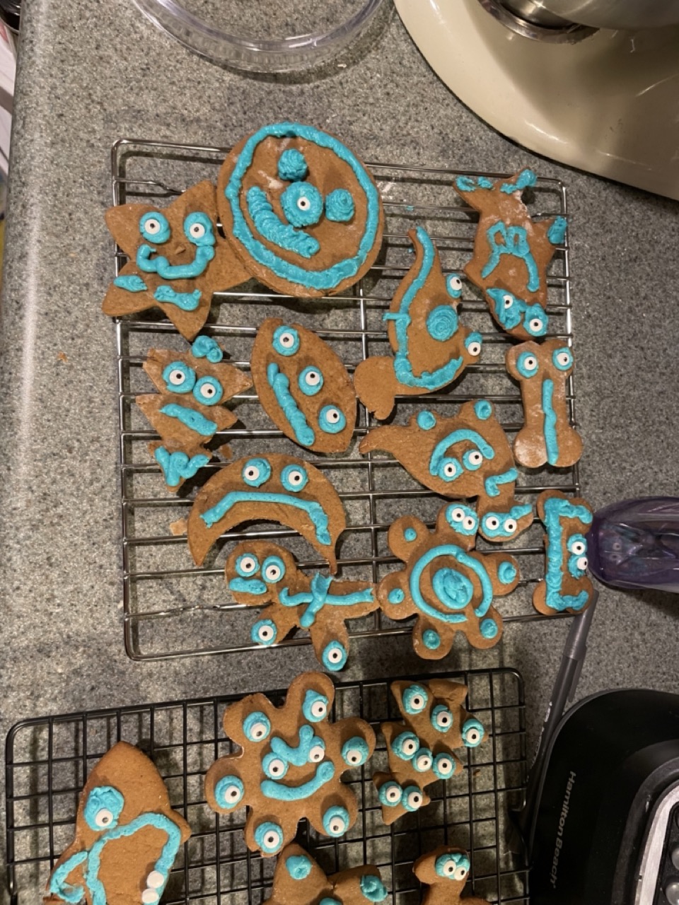 Gingerbread monster cookies with teal icing, various odd shapes with googly eyes.